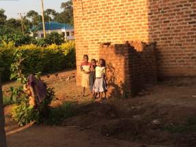 These children watched me mix paints probably wondering what fun they were going to have at school the next day with Madam Gerry! They are stood beside the family latrine & bathroom